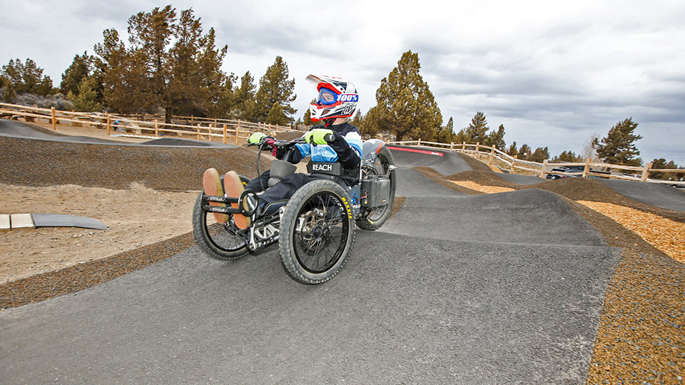 Adaptive cyclist on the pump track at Big Sky Bike Park in Bend, OR